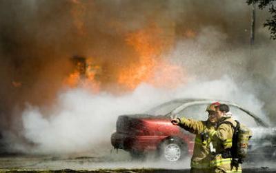 
Spokane Valley firefighters confer as they prepare to attack a house and car fire at 2714 N. Perrine Ct. 
 (Joe Barrentine / The Spokesman-Review)