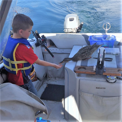 Jackson Sifford was fishing in the K&K Spring Derby with his Grandpa, Dan Lenz, when a visitor dropped in for a snack. (Courtesy)