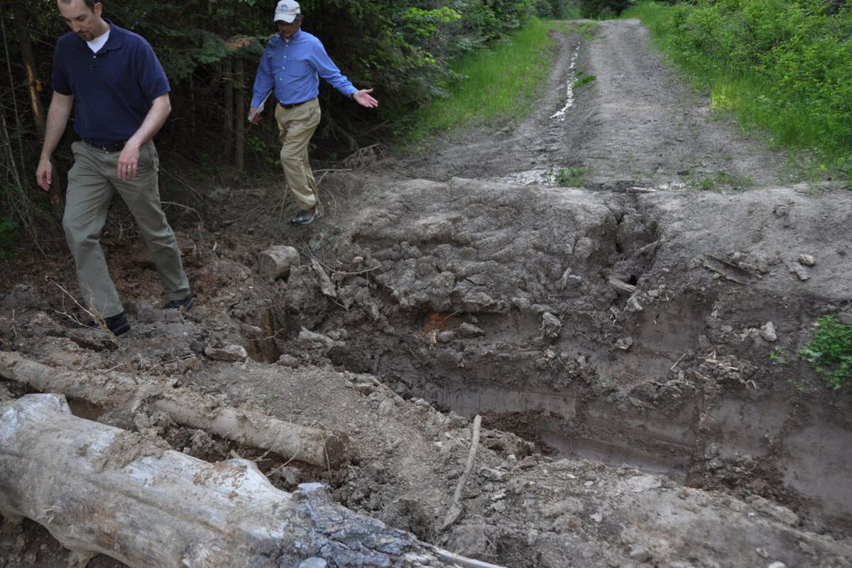 Climber and Avista engineer Aaron Henson and Jeff Lambert of the Spokane Mountaineers walk around a ditch a local landowner dug to block a county road leading to the Big Rock natural area owned by the Dishman Hills Natural Area Association. (Rich Landers)