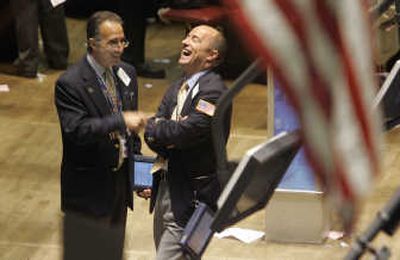 
Traders share a light moment Thursday on the floor of the New York Stock Exchange. The S&P 500 rose to 1,547.70, and the Dow shot up to 13,861.73.   Associated Press
 (Associated Press / The Spokesman-Review)