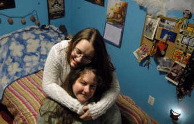 
Barbara Bisaro is hugged by her daughter Kayla, 15, in Kayla's pirate-themed bedroom at their home in Post Falls on Monday. Kayla was able to decorate her room to her liking after Barbara went through Idaho Housing and Finance Association's self sufficiency program and was able to purchase the home. 
 (Kathy Plonka / The Spokesman-Review)