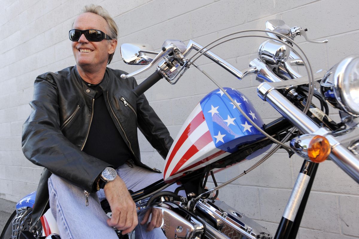 In this Friday, Oct. 23, 2009 photo, Peter Fonda, poses atop a Harley-Davidson motorcycle in Glendale, Calif. Fonda, the son of a Hollywood legend who became a movie star in his own right both writing and starring in counterculture classics like “Easy Rider,” has died. His family says in a statement that Fonda died Friday, Aug. 16, 2019, at his home in Los Angeles. He was 79. (Chris Pizzello / Associated Press)