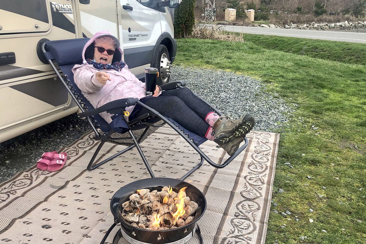 Leslie Kelly sits by the fire in a new camp chair from REI. (John Nelson)