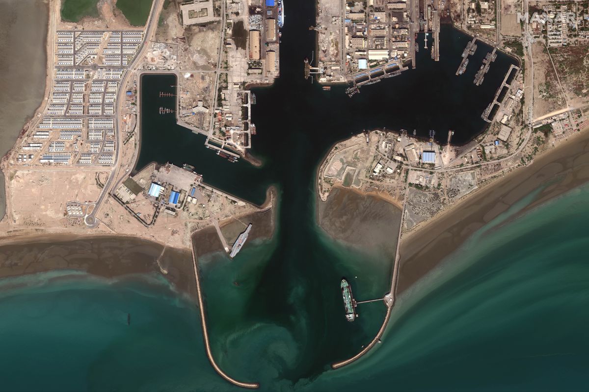 In this Feb. 15, 2020, satellite photo provided on July 27, 2020, by Maxar Technologies, a mockup aircraft carrier, center left, built by Iran is seen at Bandar Abbas, Iran, before being put to sea. Satellite photographs released Monday, July 27, showed Iran has moved the aircraft carrier out to sea likely for naval drills amid heightened tensions between Tehran and the U.S.  (HONS)