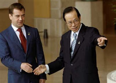 Russian President Dmitry Medvedev shakes hands with Japanese Prime Minister Yasuo Fukuda before the Outreach working lunch of the G-8 summit at the lakeside resort of Toyako, Japan, today. Associated Press
 (Associated Press / The Spokesman-Review)