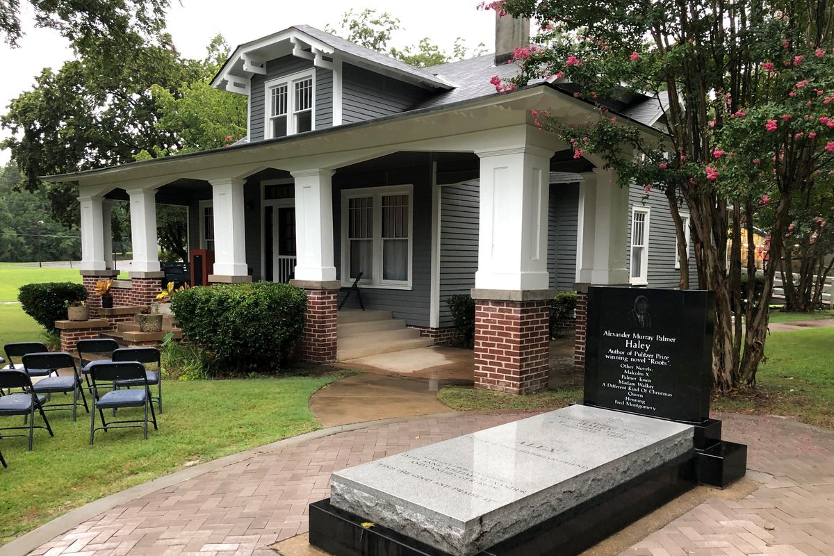 The grave of late author Alex Haley sits outside his former boyhood home on Friday, Aug. 13, 2021, in Henning, Tenn. The home is part of the Alex Haley Museum and Interpretive Center, which is honoring the writer of "Roots: The Saga of an American Family," on the 100th anniversary of Haley