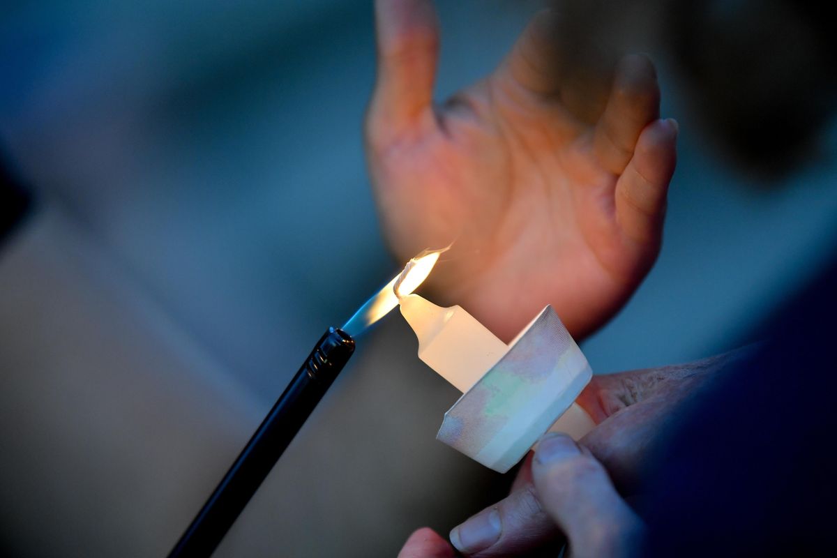 Protesters light candles during a "Lights for Liberty" vigil on Friday, July 12, 2019, at Riverfront Park in Spokane, Wash. Tyler Tjomsland/THE SPOKESMAN-REVIEW (Tyler Tjomsland / The Spokesman-Review)