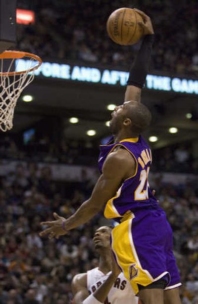 
Lakers forward Kobe Bryant throws down one of his six dunks Friday night. Associated Press
 (Associated Press / The Spokesman-Review)