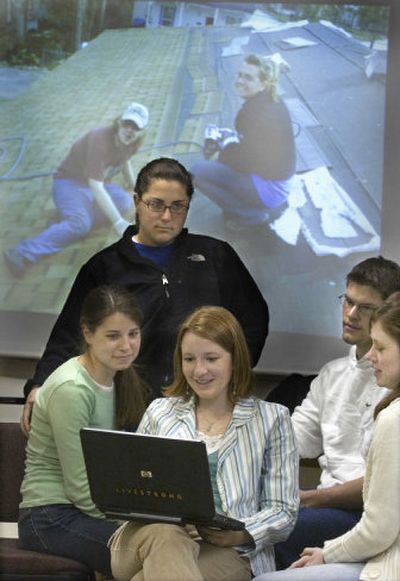 
From left, Lydia Garth, Ali Kara, Krystle Stucky, Daniel Fry and Lorin Townsend watch a slide show of photos from the hurricane damage of 2005 while more images are projected behind them. Eighteen Whitworth students traveled with advisers to Mississippi this month for a three week study program. They met Tuesday to compile photos, journals, videos and spoken words into a campus presentation. 
 (Christopher Anderson/ / The Spokesman-Review)
