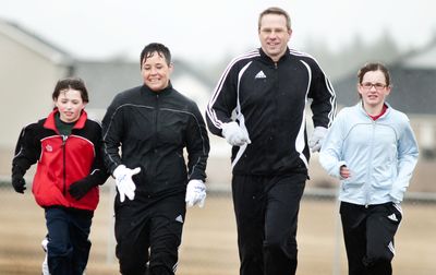 The Dingus family – from left, Claire, 8, Wendy, Tom and Olivia, 11 – have run Bloomsday together for the past three years.  (Colin Mulvany / The Spokesman-Review)
