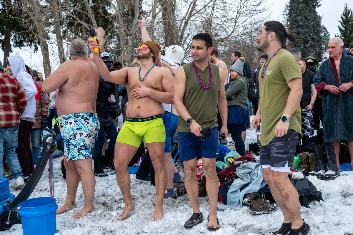 Hundreds of people line up on the shore of Lake Coeur d’Alene before braving the frigid air and water temperatures during the 2021 New Year’s Day Polar Bear Plunge, Saturday, Jan. 1, 2021, at Sanders Beach in Coeur d’Alene, Idaho.  (COLIN MULVANY/THE SPOKESMAN-REVIEW)
