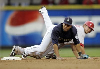 Seattle second baseman Jose Lopez, front, watches his throw to first after forcing out Los Angeles Angels' Jeff Mathis. Associated Press
 (Associated Press / The Spokesman-Review)