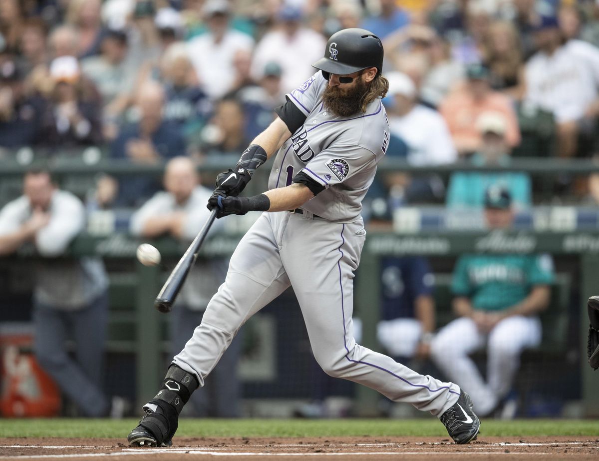 Colorado’s Charlie Blackmon hits a solo home run off Seattle Mariners starting pitcher Felix Hernandez during the first inning Friday in Seattle. (Stephen Brashear / AP)