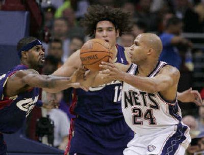 
New Jersey's Richard Jefferson is defended by Cleveland's Larry Hughes. 
 (Associated Press / The Spokesman-Review)