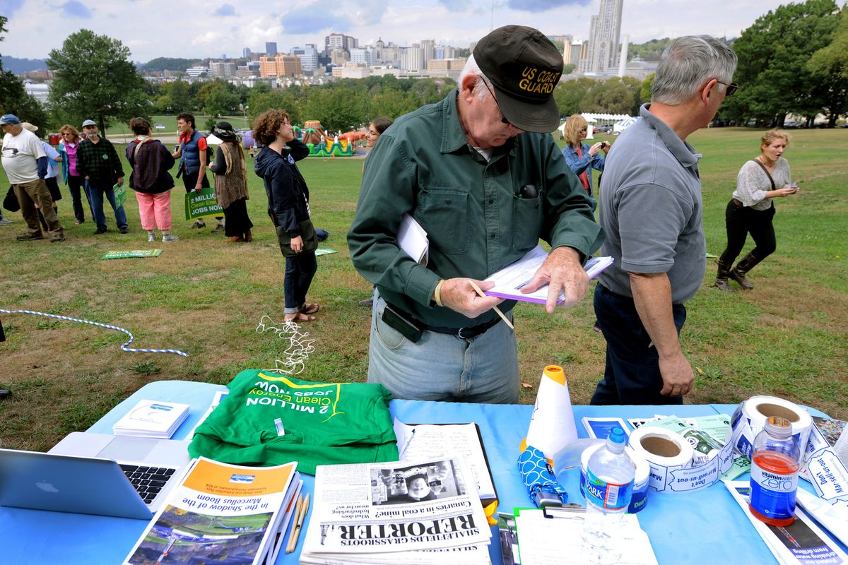 A man signs a petition during a global Frackdown Day calling for a moratorium on Shale Gas Drilling at Schenley Park in Pittsburgh, Saturday, Sept. 22, 2012. (John Heller / Fr48174 Ap)
