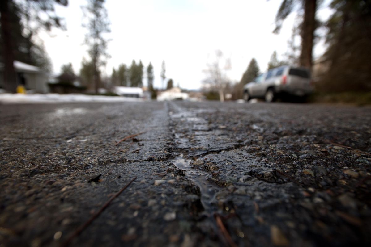 Cracks are seen in the road at South Sonora Drive on Wednesday, Feb. 28, 2018, in Spokane Valley, Wash. (Tyler Tjomsland / The Spokesman-Review)