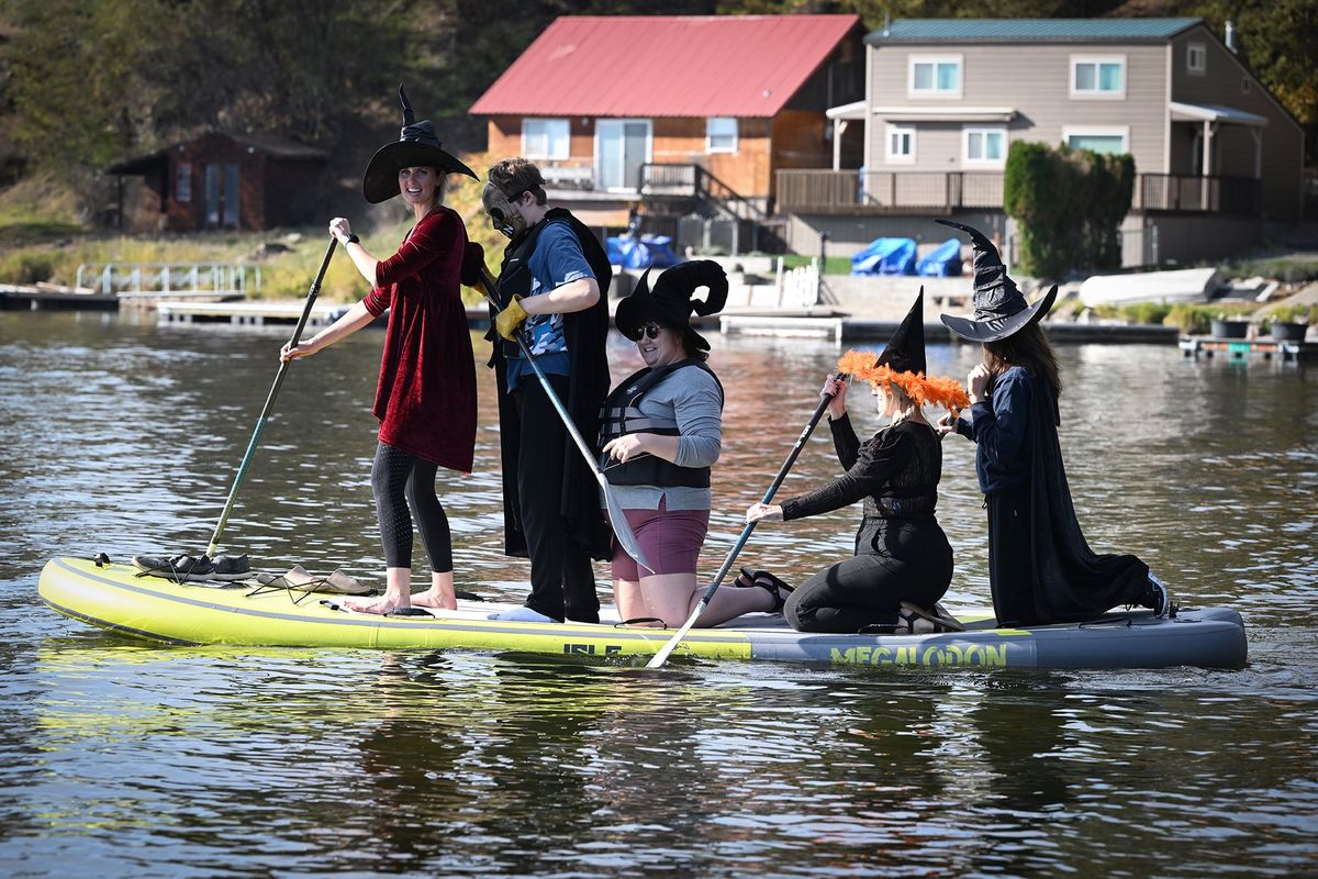 Five paddlers squeeze onto an oversized inflatable paddleboard on Newman Lake Saturday, Oct. 21, before they headed off around the lake together. The 1st Annual Witches and Warlocks Ride was dreamed up by Misty Eller, who was inspired by a similar event that happens on Lake Havasu in Arizona.  (Jesse Tinsley/The Spokesman-Review)