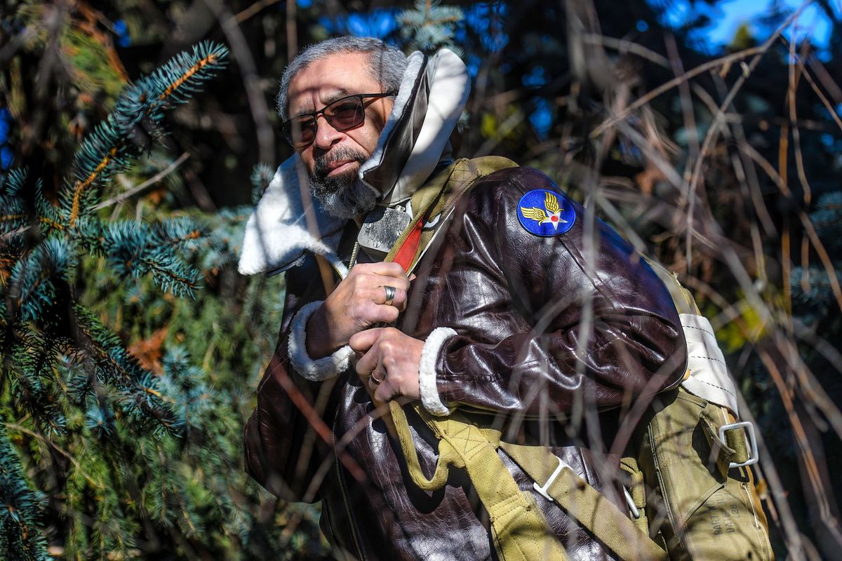 Robert L. “Bob” Bartlett is photographed wearing a replica jacket and carrying an original parachute from the 555th Battalion at his home Wednesday in Spokane Valley. He is a retired professor at Gonzaga and Eastern Washington universities, and has spent most of the past decade trying to bring more attention to the story of the 555th Battalion, which called itself the “Triple Nickles.” The group of 300 men was based out of military installations in the Pacific Northwest during the waning days of World War II, where it fought fires believed to have been caused by the Japanese balloon bombs.  (Kathy Plonka/The Spokesman-Review)