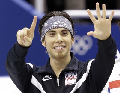 Apolo Anton Ohno displays his Olympics medal count. (Associated Press)