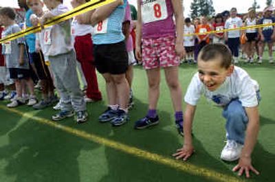 
Eight-year-old Cory Dahl hunkers down, ready to start the America's Kids Run at Joe Albi Stadium on Saturday morning. This was Dahl's first time running in the event. 
 (Photos by Holly Pickett/ / The Spokesman-Review)