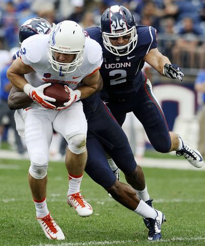 Boise State receiver Matt Miller, left, is hauled down by UConn safety Obi Melifonwu in the first half Saturday. (Associated Press)