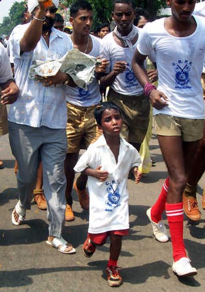 
Budhia Singh runs with soldiers during a marathon held in Bhubaneshwar in May 2006.Associated Press
 (File Associated Press / The Spokesman-Review)