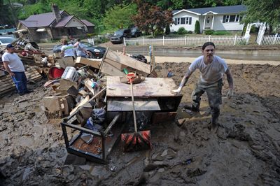 Joe Hinkle of Tattoo Joe’s works outside his flooded business Sunday in Gilbert, W.Va.  He didn’t have flood insurance for his 7-year-old business. “I can’t salvage anything at all.”   (Associated Press / The Spokesman-Review)