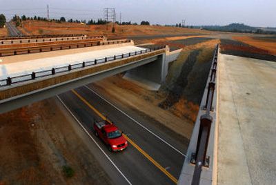 
Automobiles drive under the new overpasses for the North Spokane Corridor project on Farwell Road near Highway 2. 
 (Jed Conklin / The Spokesman-Review)