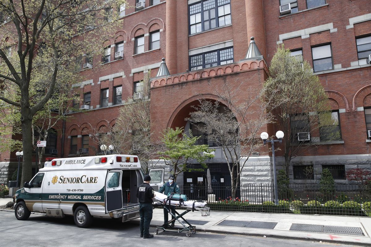 FILE - In this April 17, 2020, file photo, emergency medical workers arrive at Cobble Hill Health Center in the Brooklyn borough of New York. A grim blame game with partisan overtones is breaking out over COVID-19 deaths among nursing home residents, a tiny slice of the population that represents a shockingly high proportion of Americans who have perished in the pandemic.  (John Minchillo)
