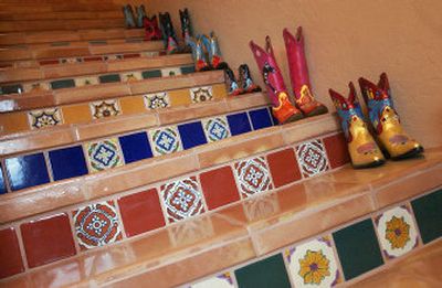 
Joann Walker painted each pair of cowboy boots that line the stairway to the second floor of the home she and her husband Howard built on Lake Roosevelt. Howard tiled the stairs himself. 
 (The Spokesman-Review)