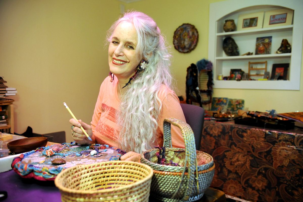 Artist Michele Mokrey works in her small studio on North Monroe Street. (The Spokesman-Review)