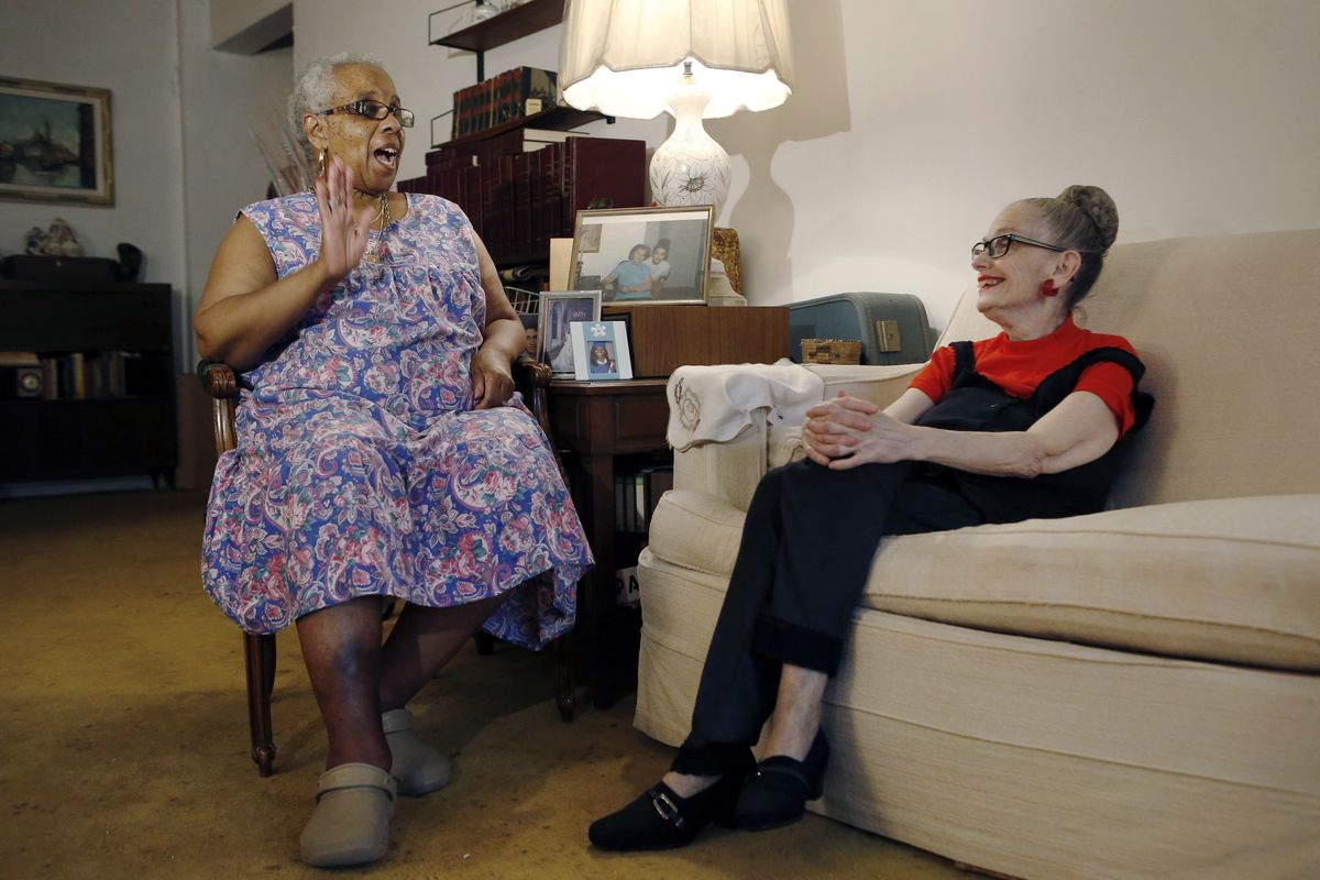 Carolyn Allen, left, recounts how she fell in the bathtub and was helped by roommate Marcia Rosenfeld, who owns the Brooklyn, N.Y., apartment where they live. The two women are roommates thanks to a home-sharing program run by a New York-based nonprofit agency. The pair have roomed together for three years. (Associated Press)