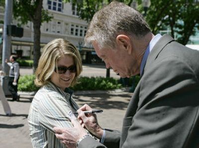 
Rep. Tom Osborne , R-Neb., autographs the arm of Jennifer Morales on a Lincoln, Neb., street on Tuesday. The congressman lost to Gov. Dave Heineman in a Republican primary for governor. 
 (Associated Press / The Spokesman-Review)