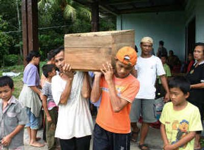 
Residents carry a coffin of one of their relatives who was killed in the earthquake on Nias island, Indonesia, Tuesday. The small Indonesian island bore the brunt of an 8.7-magnitude undersea earthquake that struck late Monday.
 (Associated Press / The Spokesman-Review)