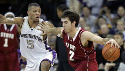 
WSU's Derrick Low (2) stiff-arms UW's Will Conroy during last month's game. 
 (Associated Press / The Spokesman-Review)