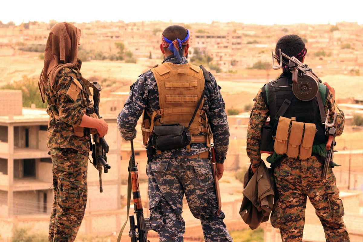 This April 30, 2017, file photo, provided by the Syrian Democratic Forces (SDF), shows fighters from the SDF looking toward the northern town of Tabqa, Syria. (Uncredited / Associated Press)