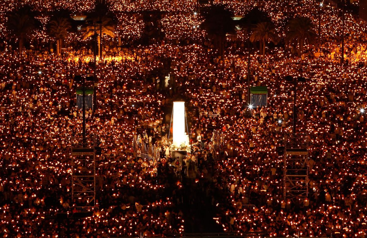 Tens of thousands attend a candlelight vigil in Hong Kong on Thursday. (The Spokesman-Review)