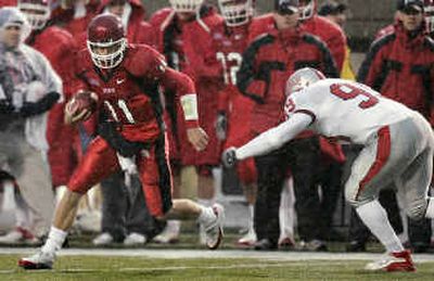
Utah quarterback Alex Smith, left, would be an unlikely Heisman recipient despite his gawdy numbers and the success of his team. 
 (Associated Press / The Spokesman-Review)