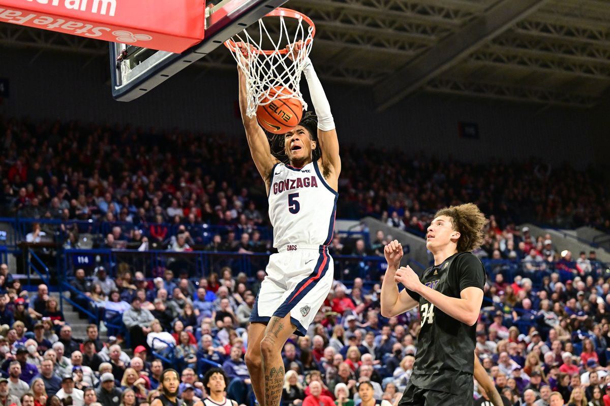 Gonzaga Bulldogs guard Hunter Sallis (5) dunks the ball against Washington Huskies center Braxton Meah (34) during the second half of a college basketball game on Friday, Dec. 9, 2022, McCarthey Athletic Center in Spokane, Wash. Gonzaga won the game 77-60.  (Tyler Tjomsland/The Spokesman-Review)