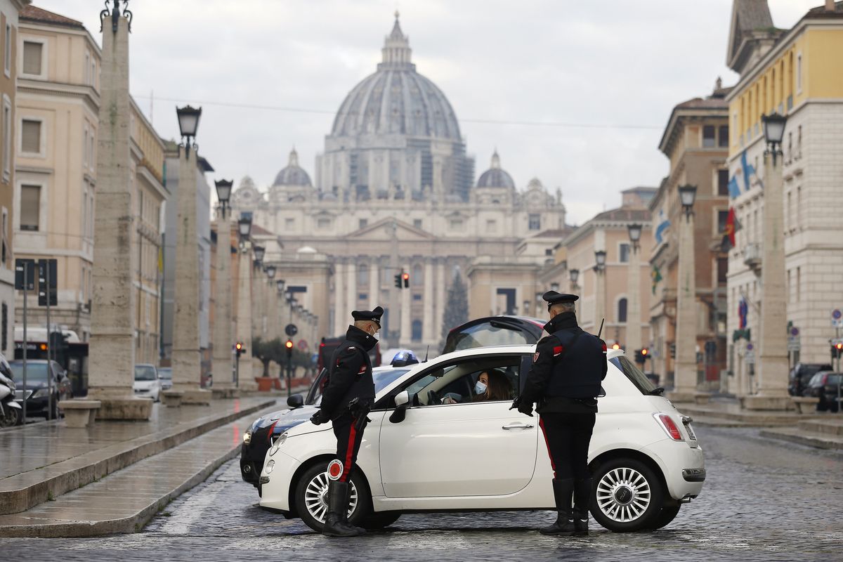 Italian Carabinieri officers check vehicles in front of St. Peter