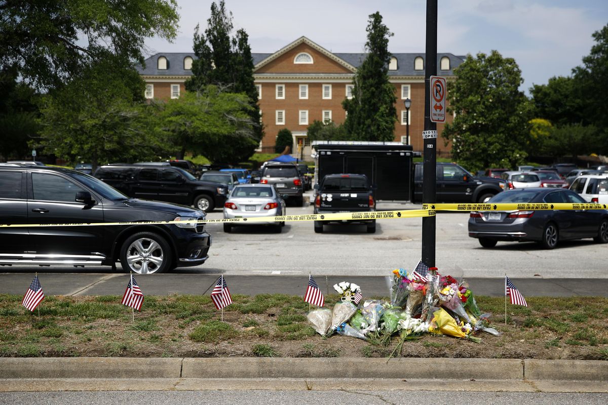 On June 1, 2019,  a makeshift memorial rests at the edge of a police cordon in front of a municipal building that was the scene of a shooting in Virginia Beach, Va. The Virginia Beach killing is one of 11 mass workplace killings dating back to 2006 in the U.S., according to a database of mass killings maintained through a partnership between AP, USA Today and Northeastern University. (Patrick Semansky / Associated Press)
