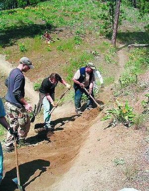 
From left, Kevin Goltz, Dan Webber and Mike Brixey build mountain biking trails at Camp Sekani.
 (Penny Schywn / The Spokesman-Review)