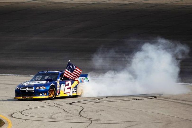 Brad Keselowski, driver of the #2 Miller Lite Dodge, celebrates with a burn out after winning the NASCAR Sprint Cup Series GEICO 400 at Chicagoland Speedway on September 16, 2012 in Joliet, Illinois. (Photo Credit: Photo by Todd Warshaw/Getty Images for NASCAR) (Todd Warshaw / Getty Images North America)
