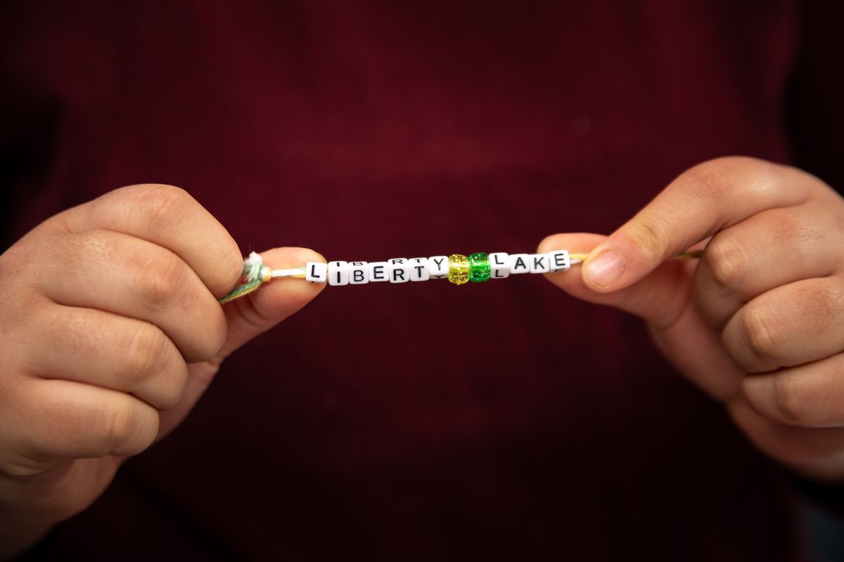 Birdie Bachman, age 14, holds up one of her handmade bracelets on June 9, 2020 at her home in Liberty Lake, Wash. The Selkirk Middle School eighth grader first started making bracelets as a class project based on community involvement, but after posting about her creations on social media, received 54 orders (as of June 9) from friends. Bachman said that she finds the hobby project to be relaxing, and she even received a donation of supplies to make more.   (Libby Kamrowski)