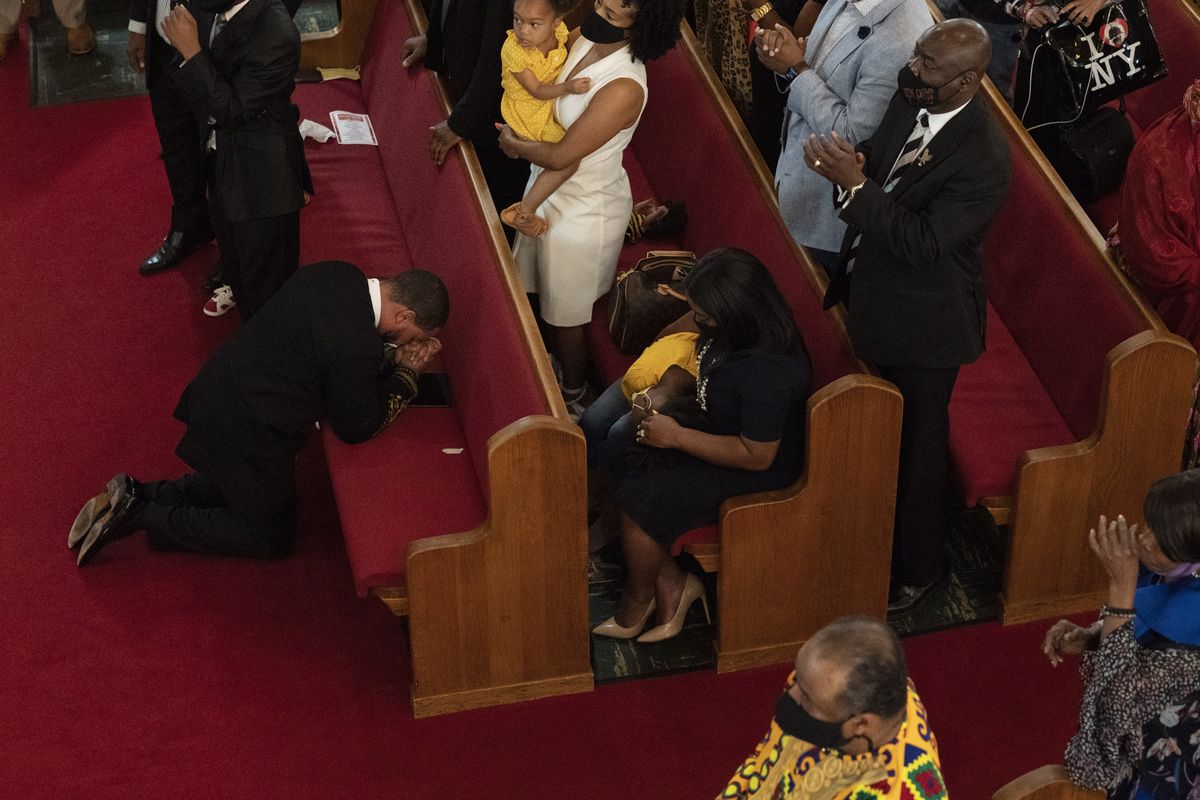 Rev. John R. Faison, Sr. kneels in prayer after preaching at a joint service for the centennial of the Tulsa Race Massacre at First Baptist Church of North Tulsa, Sunday, May 30, 2021, in Tulsa, Okla.  (John Locher)