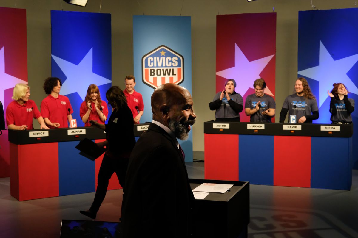 Show host Gary Stokes, General Manager of KSPS, center, smiles as Civics Bowl teams from North Central, left, and The Community School, right, get ready to test their knowledge against each other during a taping of the Civics Bowl by KSPS and the League of Women voters on Thursday, Apr 28, 2022, at KSPS in Spokane, Wash.  (Tyler Tjomsland/The Spokesman-Review)