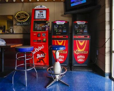 This photo taken Thursday, March 5, 2015, shows an Idaho Lottery Play Center machine, left, and two Idaho Lottery TouchTab machines in the age-controlled lounge area at 20th Century Lanes in Boise, Idaho. (AP / Otto Kitsinger)
