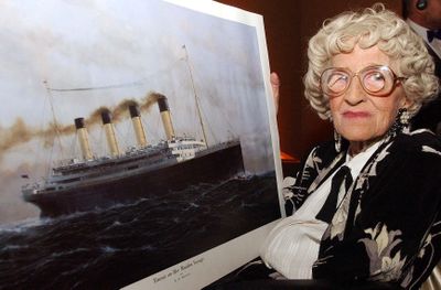 A May 19, 2003, photo from files of Millvina Dean shows the last living survivor of the Titanic disaster with a painting of the vessel, at an unknown location in England.  (File Associated Press / The Spokesman-Review)