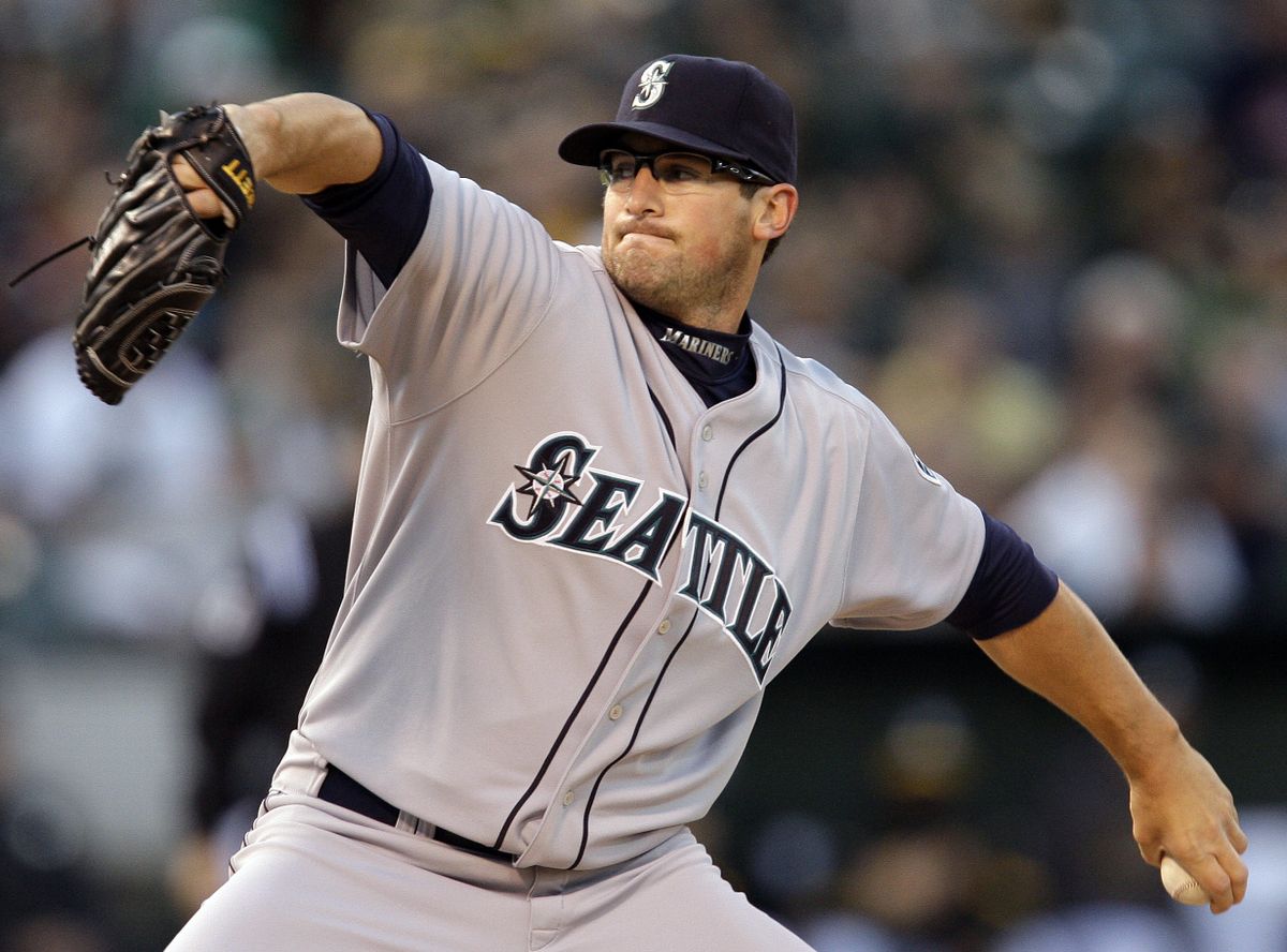 Seattle’s Ryan Rowland-Smith works against Oakland in the first inning of Friday night’s game.  (Associated Press / The Spokesman-Review)