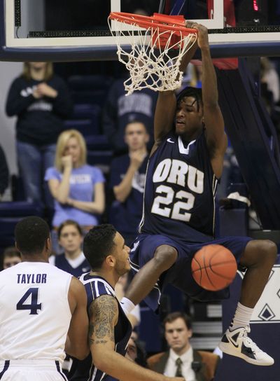 Oral Roberts forward Steven Roundtree (22) dunks the basketball as Xavier's Travis Taylor (4) watches. (Associated Press)